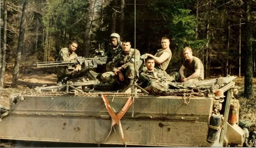 Alex, infantry squad leader, call sign Bayonet, with his squad on an armored personnel carrier in Germany