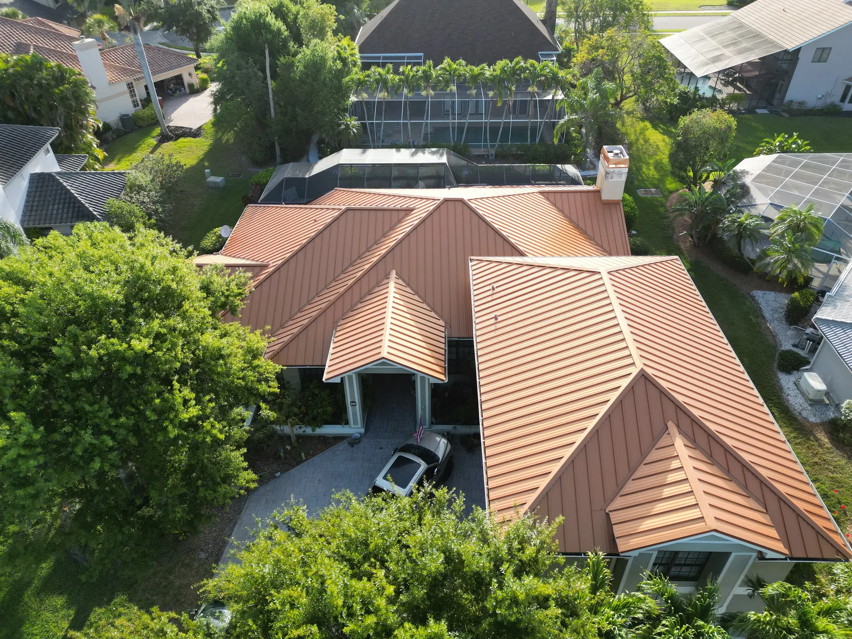 Terracotta standing-seam metal roof on a Fort Myers home